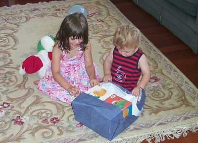 Amy and Daniel opening the bath toys I gave him