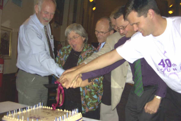 Conductors Brian Hingerty, Judith Clingan, Graham Kerrison, Christopher Burrell, Peter Young and Matthew Stuckings cut the SCUNA 40th Birthday cake