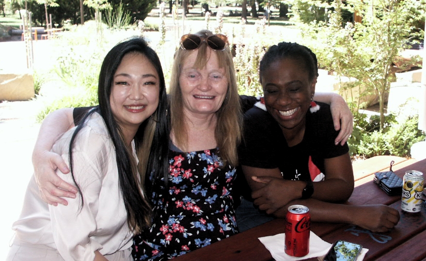 Three women hug
